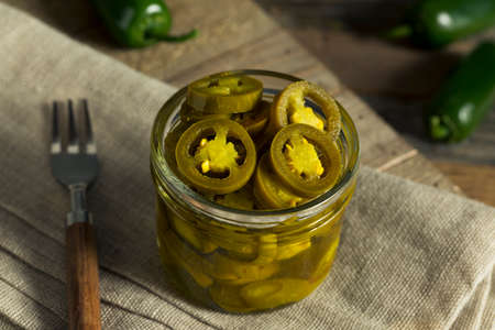 Green Organic Pickled Jalapenos in a Jarの写真素材