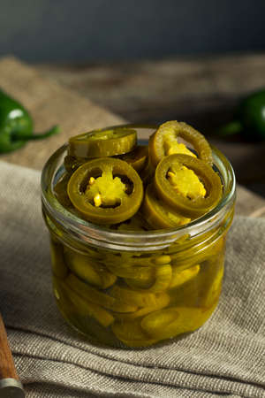 Green Organic Pickled Jalapenos in a Jarの写真素材