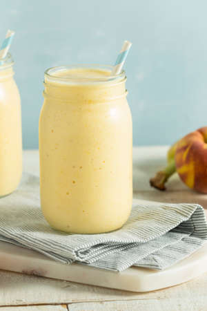 Healthy Homemade Peach Smoothie with Pineapple and Bananasの写真素材