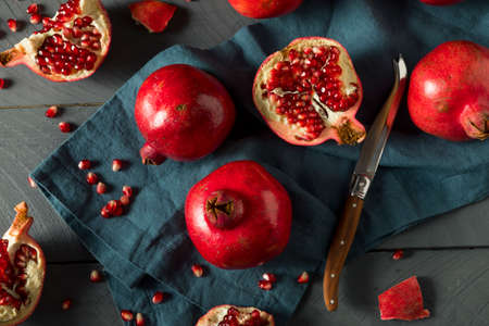 Raw Red Organic Pomegranates Splt in Halfの写真素材