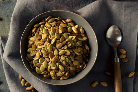 Organic Spicy Homemade Pumpkin Seeds in a Bowlの写真素材