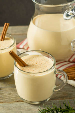 Boozy Warm Eggnog Punch with Cinnamon for Christmasの写真素材