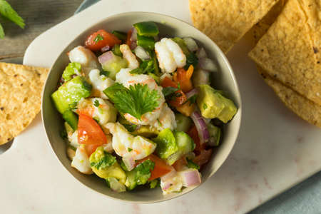 Raw Homemade Shrimp Ceviche with Veggies and Chipsの写真素材