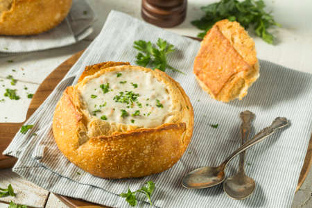 New England Clam Chowder in a Bread Bowl with Parsleyの写真素材