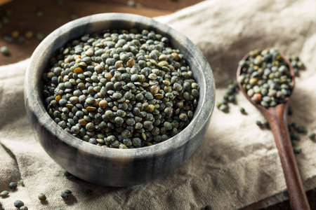 Dry Green Organic French Lentils in a Bowlの写真素材