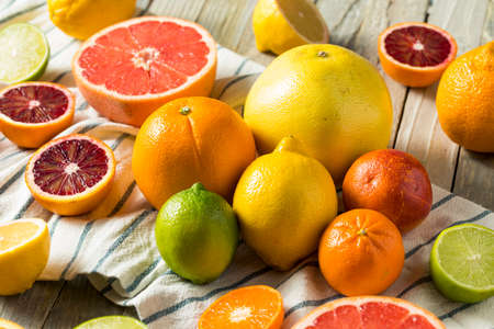 Assorted Raw Organic Citrus Fruit with Oranges Limes Lemons Grapefruit and Mandarins