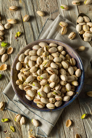 Raw Organic Green Fresh Pistachios in a Bowlの写真素材