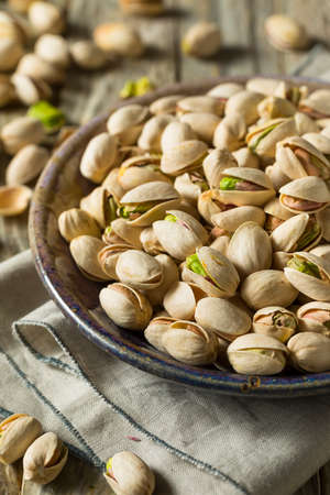 Raw Organic Green Fresh Pistachios in a Bowlの写真素材