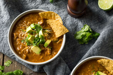 Spicy Homemade Tortilla Soup with Cheese Cilantro and Limeの写真素材