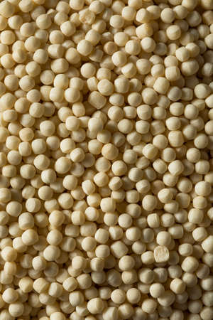 Raw Dry Organic Couscous in a Bowlの写真素材