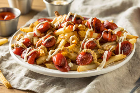 Homemade Peruvian Salchipapa Fries with Mayo Ketchup and Mustardの写真素材