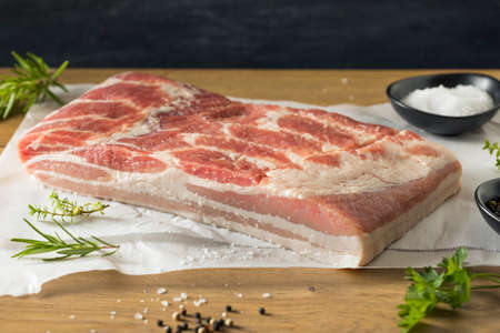 Raw Organic Pork Belly Meat with Salt and Pepperの写真素材