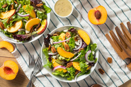 Healthy Homemade Peach Salad with Pecans Cheese and Dressingの写真素材