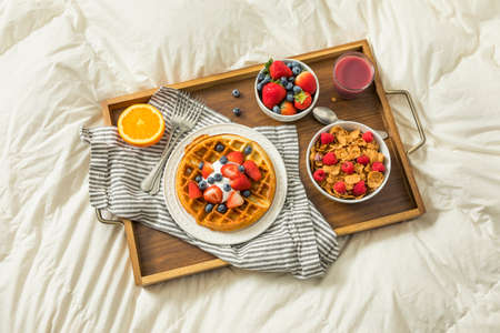 Healthy Homemade Breakfast in Bed with Waffles Fruit Cerealの写真素材