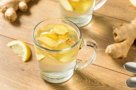 Homemade Fresh Ginger Tea with Lemon in a Mugの写真素材