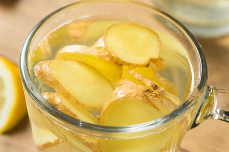 Homemade Fresh Ginger Tea with Lemon in a Mugの写真素材