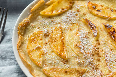 Homemade Apple Dutch Pannekoek Pancake with Powdered Sugarの写真素材
