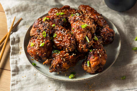 Homemade Spicy Korean Chicken Wings with Sesame Seedsの写真素材