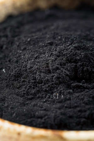 Raw Organic Black Activated Charcoal in a Bowlの写真素材