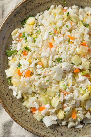 Raw Organic White Cauliflower Rice in a Bowlの写真素材