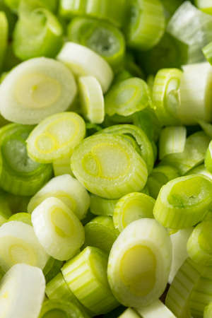 Raw  Organic Chopped Green Onions on a Cutting Boardの写真素材