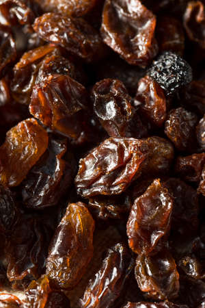 Organic Dried Brown Raisins in a Bowlの写真素材