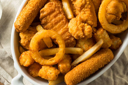 Homemade Deep Fried Munch Basket with French Fries Tater Tots and Chickenの写真素材
