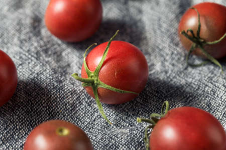 Raw Red Heirloom Cherry Tomatoes in a Bowlの写真素材