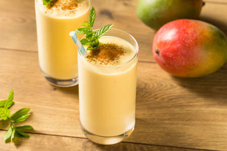 Homemade Sweet Indian Mango Lassi Smoothie with Mintの写真素材