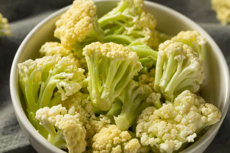 Raw White Baby Cauliflower Florets in a Bowlの写真素材