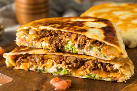 Homemade Beef Crunchwrap Quesadilla with Cheese Lettuce and Tomatoの写真素材