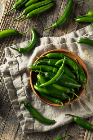 Raw Green Organic Serrano Peppers in  a Bowlの写真素材