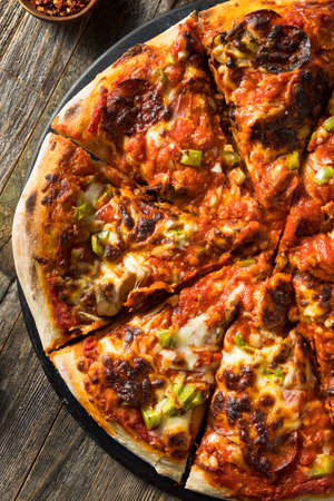 Homemade Louisville Style Supreme Pizza with Pepperoni and Mushroomの写真素材