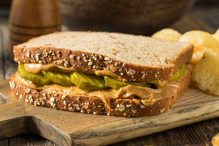 Homemade Peanut Butter and Pickle Sandwich with Chipsの写真素材