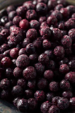 Refreshing Organic Frozen Blueberries in a Bowlの写真素材