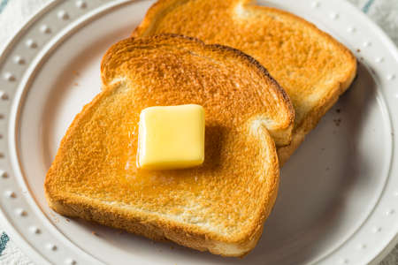 Homemade Warm Buttered Toast for Breakfast on a Plateの写真素材