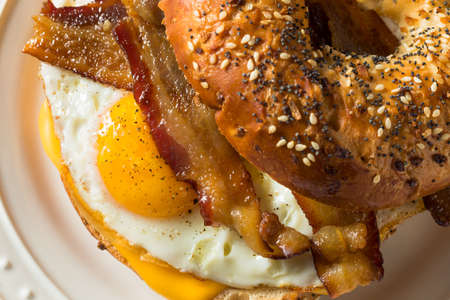 Homemade Fried Egg Bagel Sandwich with Cheese and Baconの写真素材