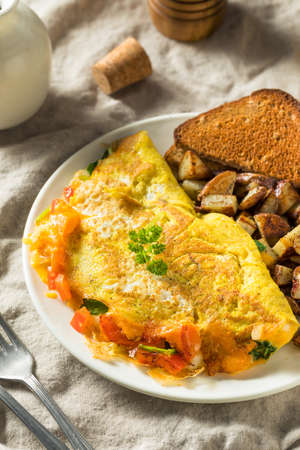Homemade Veggie Omelette with Cheese Potatoes and Toast