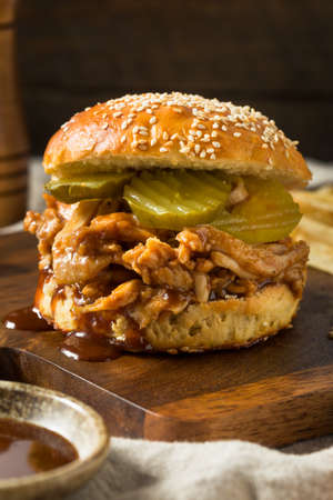 Homemade BBQ Pulled Chicken Sandwich with PIckles and Friesの写真素材