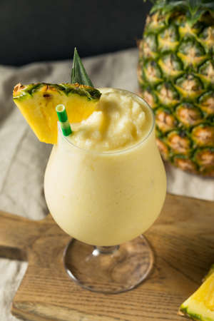 Boozy Frozen Pina Colada Cocktail with Coconut Creamの写真素材