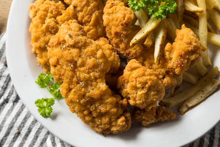 Deep Fried Chicken Tenders and Fries with Sauceの写真素材