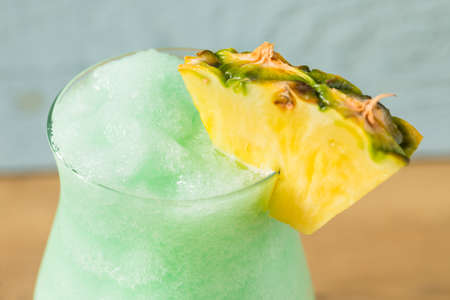 Boozy Frozen Blue Hawaii Cocktail with PIneapple and Curacaoの写真素材