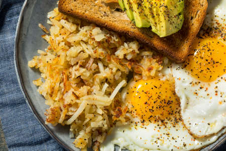 Homemade Fried Shredded Hashbrowns and Eggs for Breakfastの写真素材