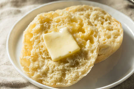 Homemade Toasted English Muffins with a Tab of Butterの写真素材