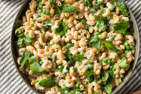 Healthy Homemade Macaroni and Cheese with Peas Spinach and Basilの写真素材