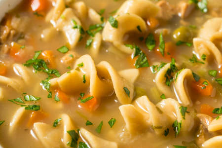 Homemade Chicken Noodle Soup with Peas and Carrotsの写真素材