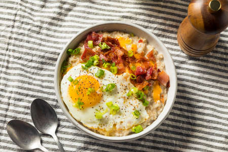 Healthy Homemade Savory Oatmeal Breakfast Bowl with Egg and Baconの写真素材