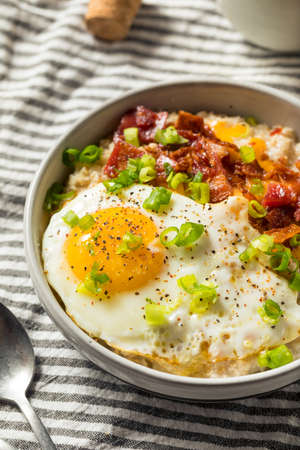 Healthy Homemade Savory Oatmeal Breakfast Bowl with Egg and Baconの写真素材