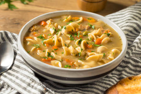 Homemade Chicken Noodle Soup with Peas and Carrotsの写真素材