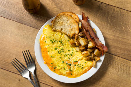 Homemade Healthy Cheese Omelet for Breakfast with Potatoes and Baconの写真素材